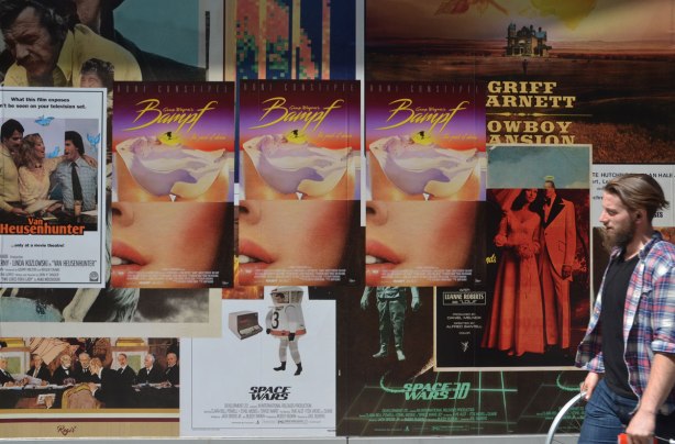 detail of an art installation that is a wall of fake movie posters