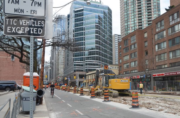 A digger and other equipment working on a torn up section of Bay street. 