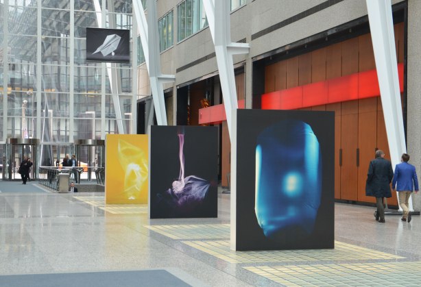 A picture taken inside the Allan Lambert Gallery at Brookfield Place, photos by Sjoerd Knibbeler, a series called Current Study large pictures standing in the middle of the gallery, as well as series called "Paper Planes" which are hung from the ceiling