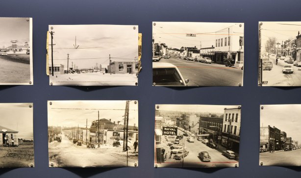 old photographs, black and white, of small towns, in a display case, as part of an exhibit called Cutlines, old photos from the Globe and Mail collection