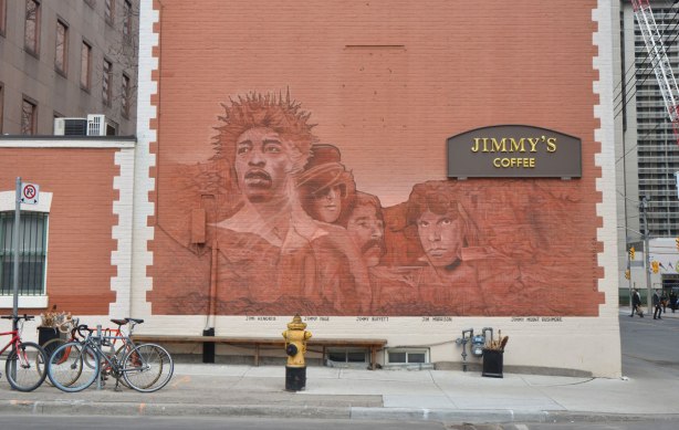 mural on the side of Jimmys coffee, monochromatic in rust, pictures of what Mount Jimmy Rushmore would like, four famous Jimmys, Jimi Hendrix, Jimmy Page, Jimmy Buffett and Jim Morrison