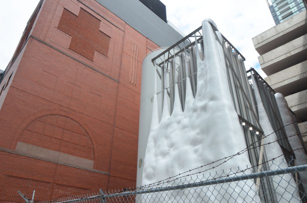 part of the addition that was added to the Red Cross building, two cross shaped features in contrasting brick on the upper levels. In front of that building are large compressed gas tanks. 