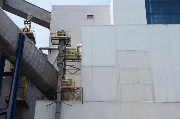 close up of the white Redpath Sugar processing plant, grey metal covers on conveyor belt tunnels and vents
