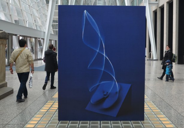 A picture taken inside the Allan Lambert Gallery at Brookfield Place, photos by Sjoerd Knibbeler, a series called Current Study large pictures standing in the middle of the gallery, as well as series called "Paper Planes" which are hung from the ceiling
