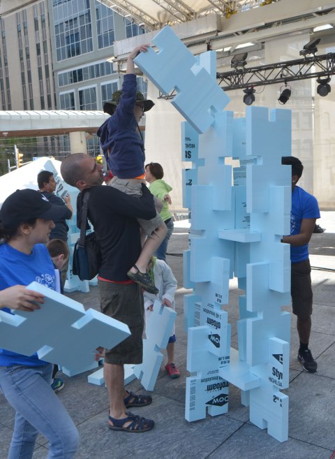 competition to build the highest, strongest tower out of hard styrofoam blocks, children and adults working together.