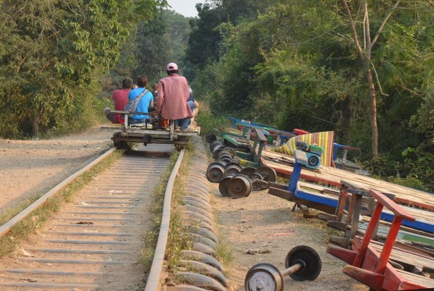 riding the bamboo train on old train tracks from the French colonial days. Parts of train 'cars' are beside the track. 