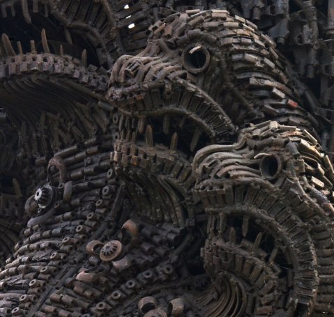 close up of Naga sculpture made with parts of destroyed weapons. - three of the heads. 