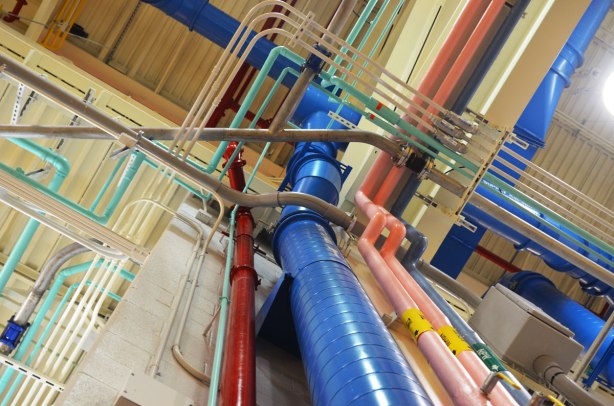 A myriad of pipes running up walls and across the ceiling, blue, pink, red, grey, all colour coded, interior, Leslie Barns 