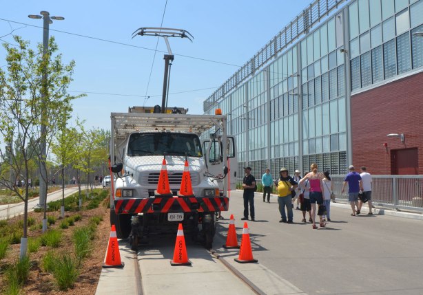 a special TTC truck sits outside Leslie Barns TTC facility on Doors Open day, the truck is designed to run on streetcar tracks and is used to repair tracks and wires. There are people looking at the truck
