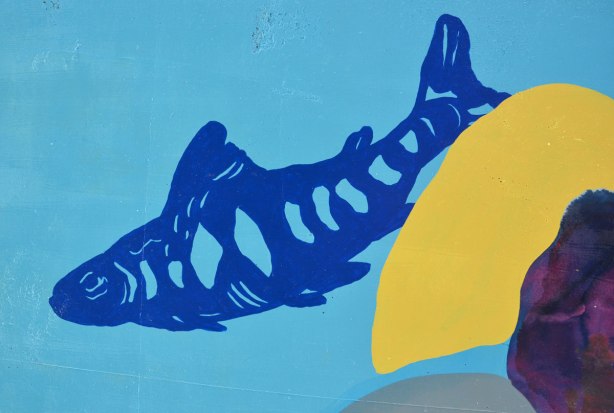 street art painting of a blue fish on light blue background, stylized