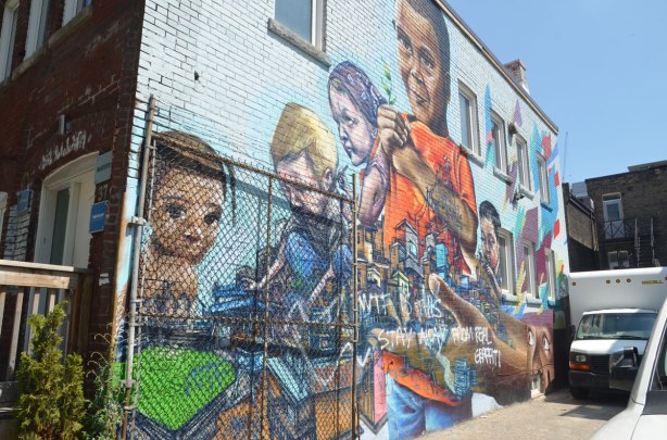 mural on the side of a building, kids playing