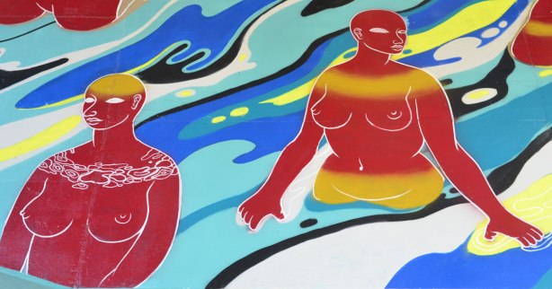 part of a mural of water and topless red women either walking or standing in the water