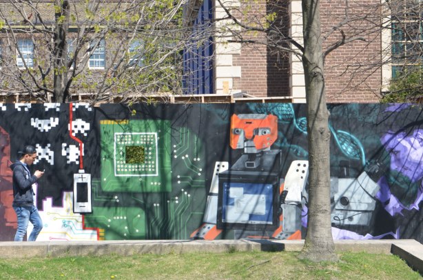 part of a mural on an artwall on hoardings around a construction site for a new engineering building at the University of Toronto, a robot cat