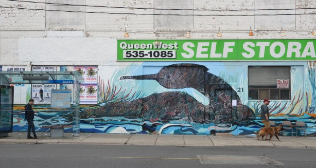 large mural of a water fowl sitting on the water on the old white Queen West self-storage building. 