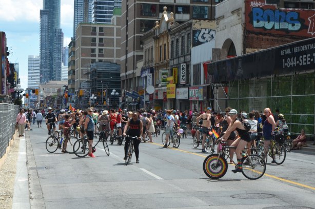 walkers in a dyke march in Toronto - a large group of cyclists on Yonge Street, Dykes on bikes