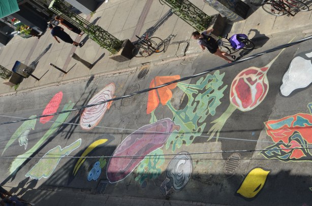 view from above of a mural on a street, fruits and vegetables, carrotes, eggplant, watermelon, beet, mushroom, lemon, 