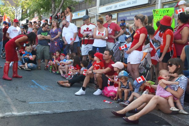 woman reporter interviewing the crowd waiting for a parade