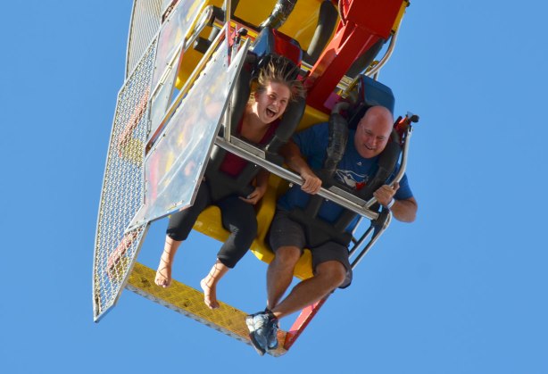 two people upside down on a ride at the CNE,