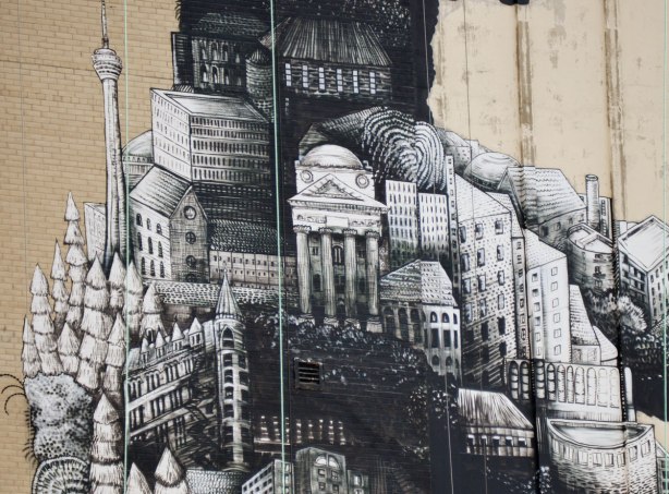close up of mural made up of toronto landmarks like the cn tower and the gooderham flatiron building 