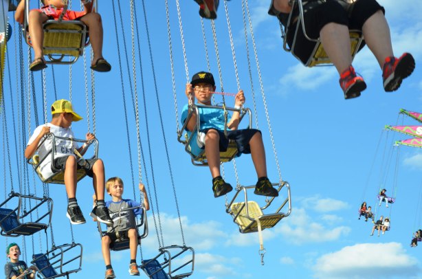 lots of people in swings suspended by chains, about to twirl around at the CNE