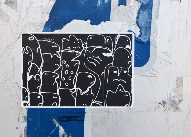 black and white sticker graffiti on the side of a Bell telephone box