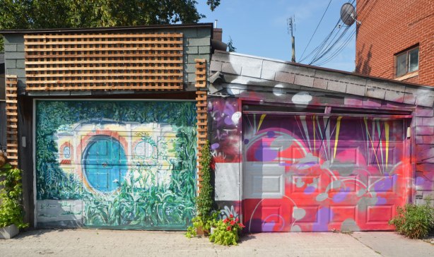 two adjacent garage doors, one with a bright abstract design and the other with a garden scene 
