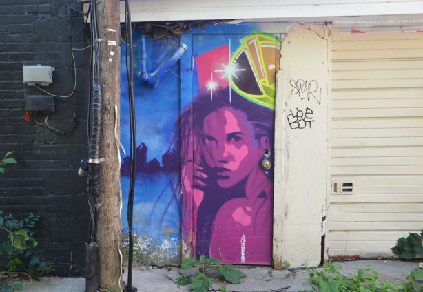 streeet art picture of a woman in pink and purple 