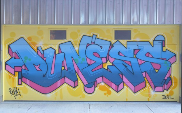 text street art painted on a garage door