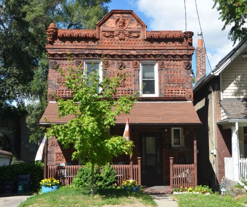 house covered with terra cotta tiles with different designs on them. 