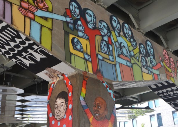 mural of people on a bent of an underpass