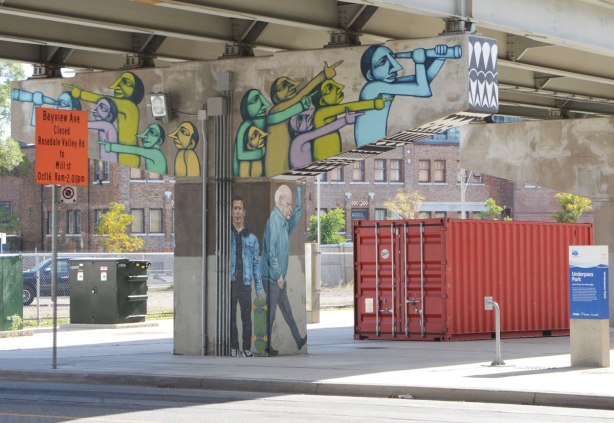 paintings on a bent holding up a ramp. Two men standing on the pillar, and a group of people with telescopes looking upward and pointing. 