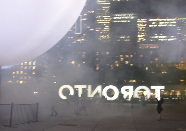 large white globe lets off steam or fog in Nathan Phillips square.