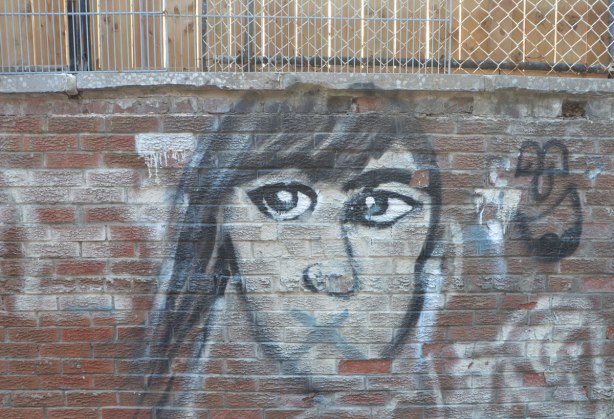 roughly drawn head with hair on one side, brown eyes, and an X for a mouth