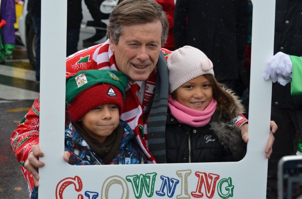 Santa Claus parade - Toronto mayor JOhn Tory poses with two kids at the start of the parade 