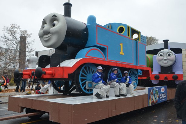 Santa Claus parade - a float with a very large replica of Thomas The Tank Engine with three kids sitting beside it. 