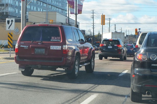 red car with a sticker on the back that says Donald Trump 2016 Make America Great Again.