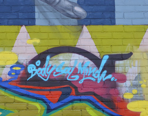 The words body, souls, and mind painted on a mural