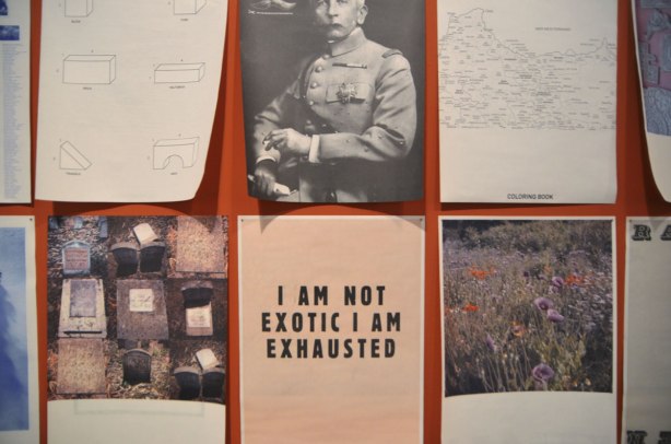 Part of an exhibit by Yto Barrada of a series of posters printed on paper and loosely tacked to the wall, of images and words. 6 shown in this photo. Including one that only has a few word on it, I am not exotic I am exhausted. 