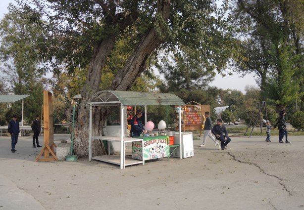 a vendor at an amusement park sells cotton candy. 