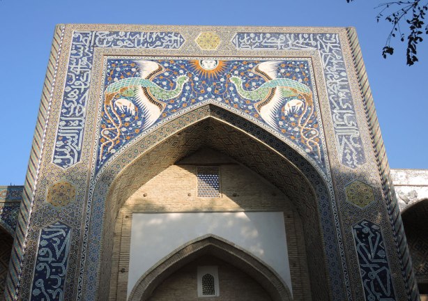 phoenix and sun made of mosaic tiles over the entrance of a madrassah in Bukhara, the Nadir Divan Begi Madrasah