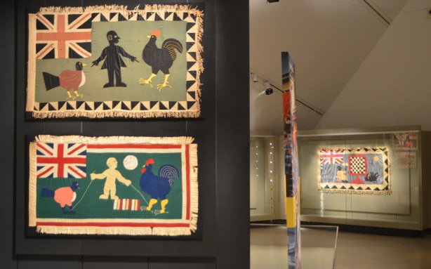 Fante asafo flags from Ghana, two on display in a museum, chickens and roosters, 