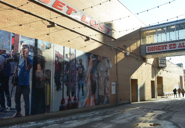 part of a mural in Honest Eds Alley by Matthew Monteith showing people walking past the windows of Honest Ed's store, large scale photo