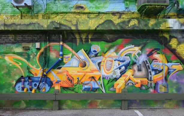 part of a larger mural, geometric and abstract shapes in many colours. 