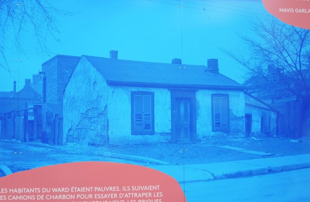 part of larger mural, reprints in blue tones of historical photos from city archives of ould buildings from the part of the city called The Ward that was demolished in the 1950's to make way for new City Hall