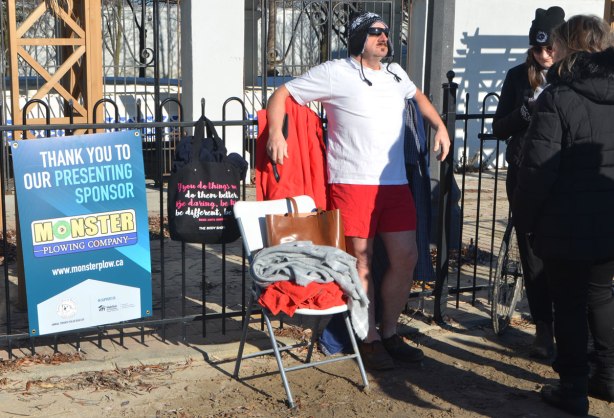 people participating in the 12th annual polar bear dip at Sunnyside Park in Toronto, in the icy cold water of Lake Ontario