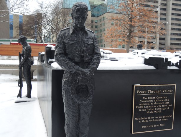 two soldiers stand vigil at the corners of a memorial, sculptures, 