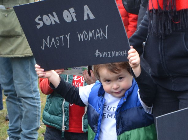 a boy holds up a sign that says Son of a Nasty Woman, #whyimarch, Womens March, toronto 