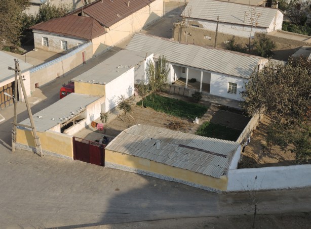 looking down into a courtyard of a residence in Nurata Uzbekistan, looking from the top of a hill