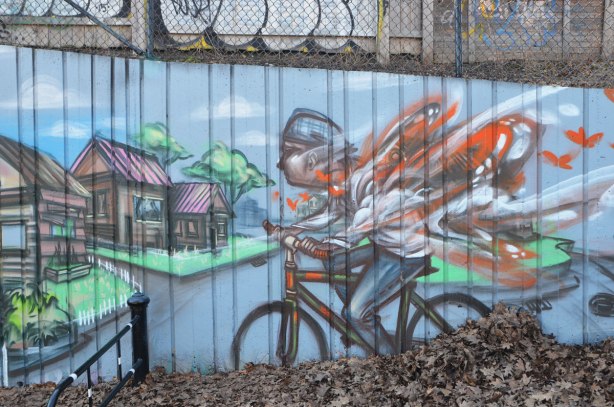 part of a larger mural by elicser in Monarch Park - a cyclist is going fast as he goes downhill