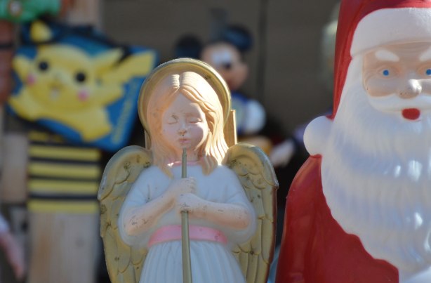 a plastic Santa Claus, a plastic angel and a pokemon
